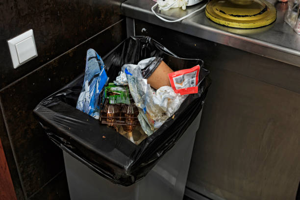 Kitchen trash bin full of trash